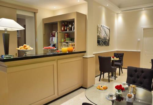 a bar in a hotel room with a table at LH Hotel Lloyd Roma in Rome