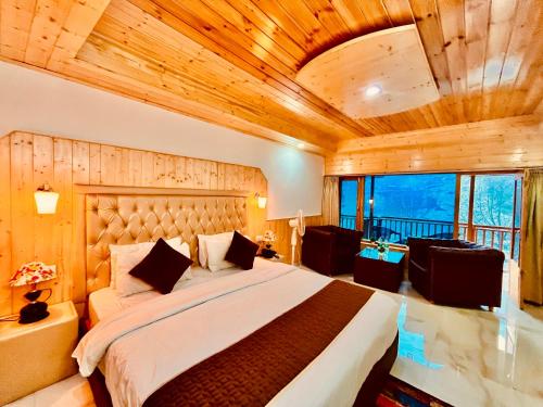 a bedroom with a large bed with a wooden ceiling at Pinewood Lodge in Ooty