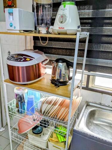 a shelf in a kitchen filled with food at Homestay D'Lapang near KLIA in Sepang