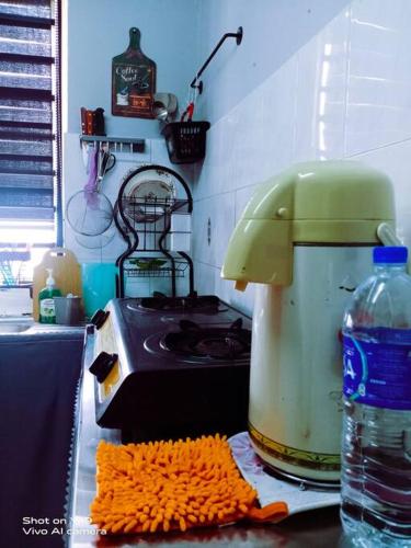 a kitchen counter with a blender and a stove at Homestay D'Lapang near KLIA in Sepang
