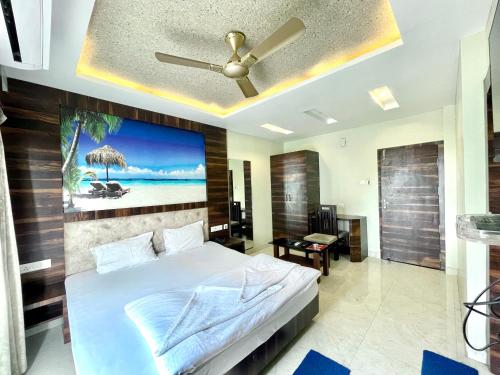 a bedroom with a bed and a ceiling fan at Hotel R R . Puri fully-air-conditioned-hotel near-sea-beach-&-temple with-lift-And restaurant-availability in Puri