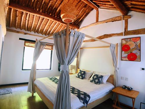 a bedroom with a bed with a canopy at 隐谷私院The Great Wall Valley in Gubeikou