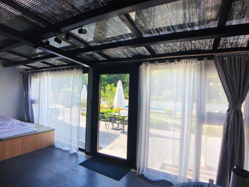 a bedroom with sliding glass doors and a patio at 隐谷私院The Great Wall Valley in Gubeikou
