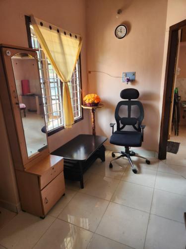 a salon with a chair and a mirror at SHARADHA NIVAS in Sringeri