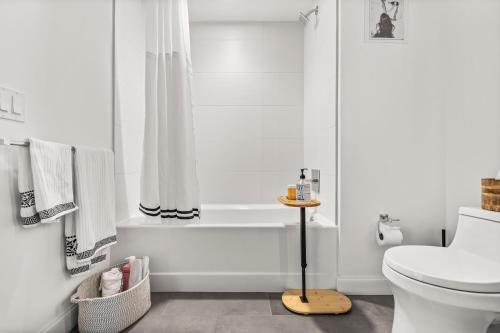 a bathroom with a toilet and a bath tub at Boston West End Penthouse Edition in Boston