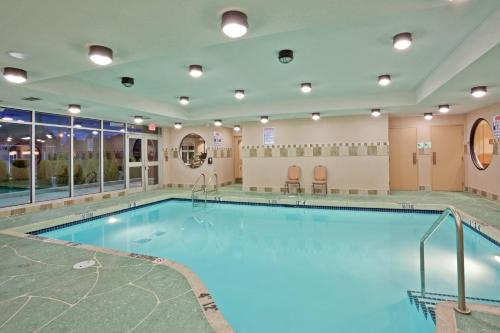 a pool in a hotel room with a large pool at Holiday Inn Hotel & Suites Surrey East - Cloverdale, an IHG Hotel in Surrey