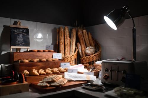 a bakery with baskets of bread and pastries on a counter at Holiday Inn Express Zhuhai Gongbei by IHG in Zhuhai