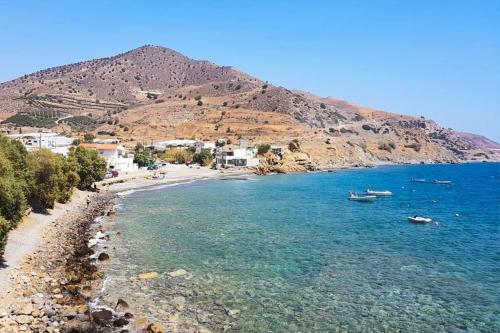 a view of a beach with boats in the water at Seafront Villa Cside w BBQ and private yard in Andiskárion