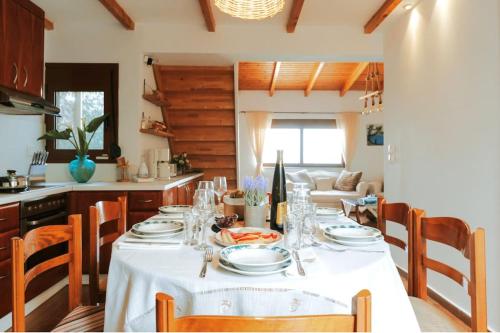 a dining room with a table with a white table cloth at Seafront Villa Cside w BBQ and private yard in Andiskárion