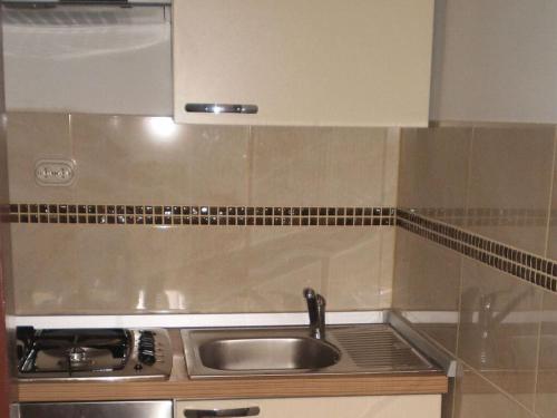 a kitchen with a sink and a stove at Licul Modern retreat in Kukci