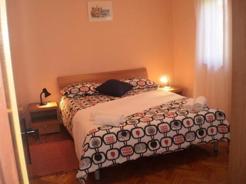 a bedroom with a bed with a black and white comforter at Licul Modern retreat in Kukci