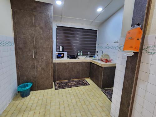 a small kitchen with a sink and a window at Sun Shine Home by Ipoh Maju Stay in Ipoh