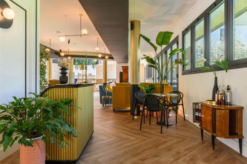 a lobby with tables and chairs and windows at Together Florence Urban Resort in Florence