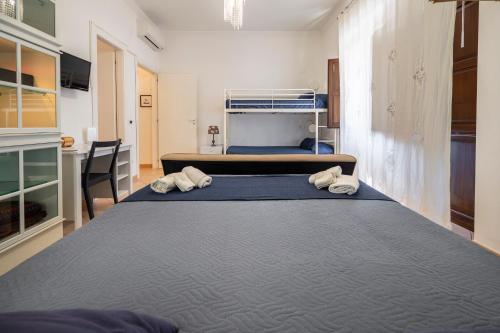 a large bed in a room with two bunk beds at Zanzibar - Charming Rooms and Apartments in Avola