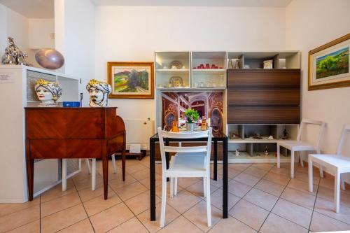 a dining room with a table and a table and chairs at Zanzibar - Charming Rooms and Apartments in Avola