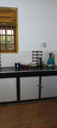 a kitchen with a black counter top in a room at ONELI VILLA MIRISSA in Mirissa