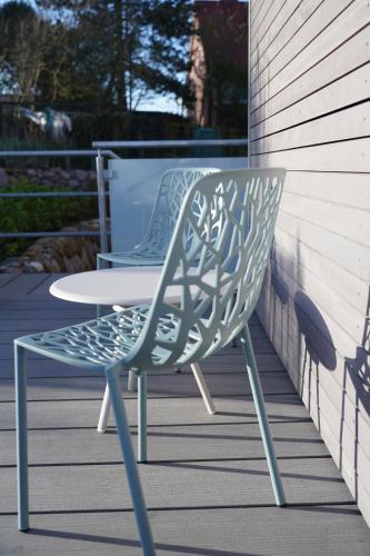 a chair sitting on a porch with a table at Endlich Theda in Juist