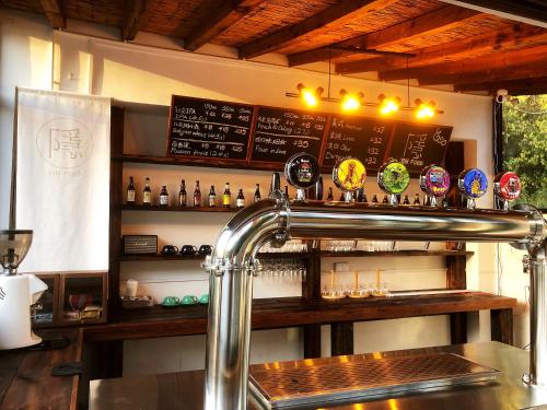 a bar with a counter with alcohol bottles on it at 隐谷私院The Great Wall Valley in Gubeikou