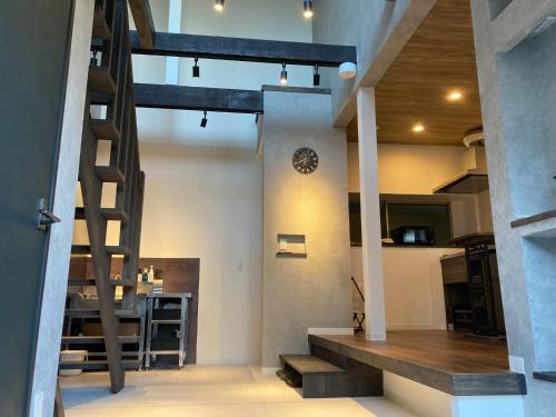 a room with stairs and a clock on a wall at KiCHi - Vacation STAY 15503 in Awaji