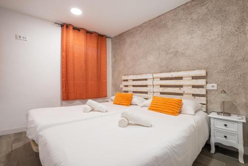 a bedroom with two beds with orange and white pillows at Att Cartagena Centro Histórico in Cartagena