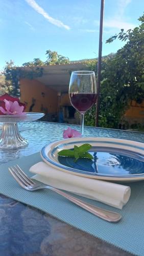 a table with a plate of food and a glass of wine at Casa da Volta - Alentejo - S. Julião in Portalegre