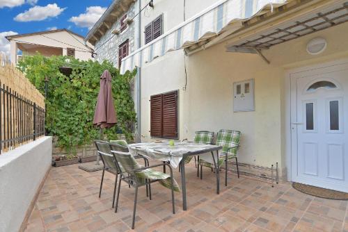 eine Terrasse mit einem Tisch, Stühlen und einem Sonnenschirm in der Unterkunft Studio für 4 Personen ca 85 qm in Premantura, Istrien Istrische Riviera in Premantura