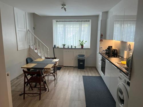 a kitchen and dining room with a table and a table and chairs at Stay in maison de metre in Etterbeek in Brussels