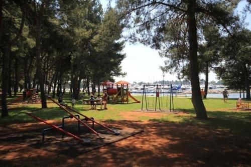 a park with a playground and a swing set at Ferienwohnung für 4 Personen ca 45 m in Novigrad, Adriaküste Kroatien Westküste von Istrien in Karpinjan