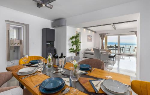 a dining room with a table with plates and wine glasses at Apartman 2A in Breza