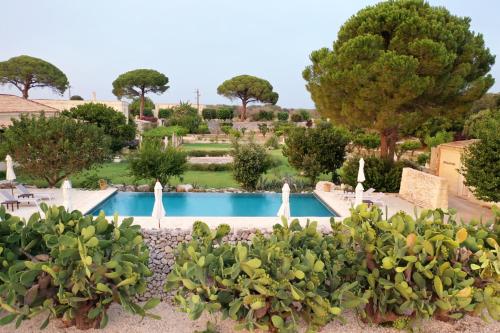 a view of the pool at a resort at MASSERIA LILEI in Lizzanello