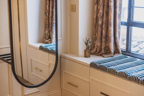 a dressing room with a mirror and a window at Hôtel Singulier Bordeaux - Boutique Hôtel & Spa Anne Semonin in Bordeaux