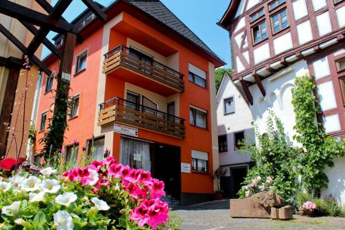 an orange building with flowers in front of it at Pensione Italia in Alf