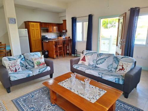 a living room with two couches and a coffee table at You 4 Ric Apartment 2: Fully-furnished 2-bedroom in Choiseul