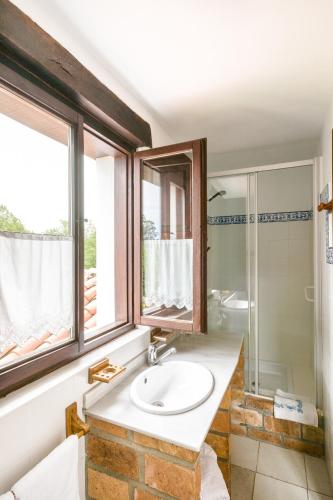 a bathroom with a sink and a shower at Posada La Charola in Lamadrid