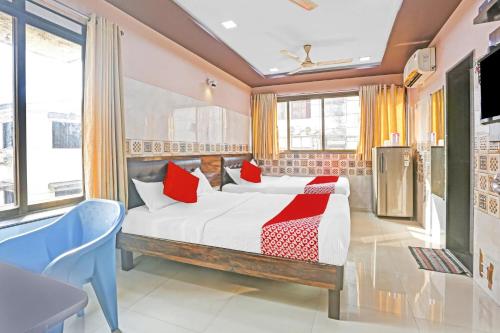 a bedroom with a bed with red pillows at OYO Flagship Hotel Pakeeza in Mumbai