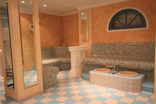 a bathroom with a tub and a sink and a shower at Appartementhaus am Fichtelberg in Kurort Oberwiesenthal