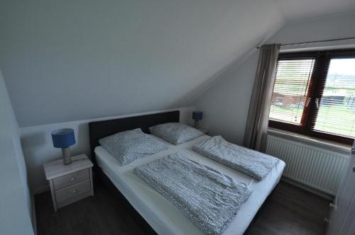 a bedroom with a bed with two pillows on it at Ferienwohnung für 2 Personen ca 45 qm in Lütow, Ostseeküste Deutschland Usedom in Lütow