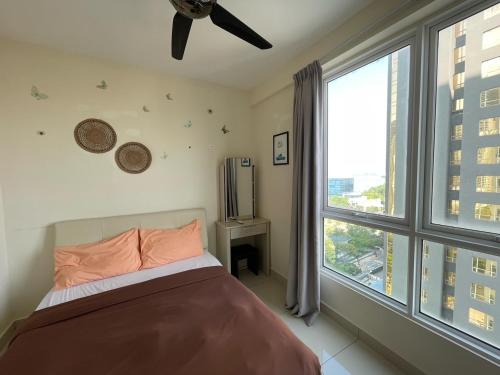 a bedroom with a bed and a large window at Penang Mansion One Suites By AuroraHomes in George Town