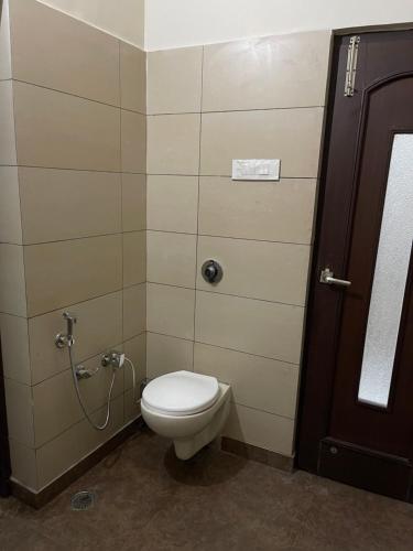 a bathroom with a white toilet in a stall at Urban Oasis in Amritsar