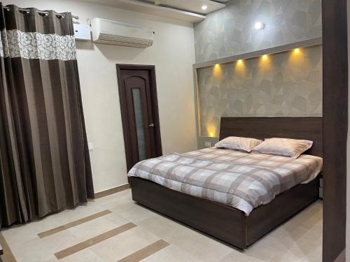 a bedroom with a large bed and a window at Urban Oasis in Amritsar