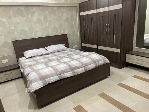 a bedroom with a large bed and a dresser at Urban Oasis in Amritsar
