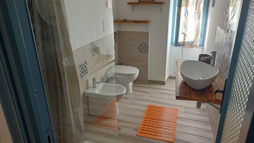La salle de bains est pourvue de toilettes, d'une baignoire et d'un lavabo. dans l'établissement Les Portes Blaves, à Alghero