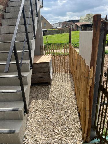a fence next to a staircase with a gate at Boven de paarden @ de Hoeveschuur in Riemst