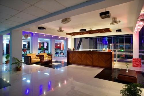 a lobby with couches and a bar in a building at Hiltown Hotel in Sylhet