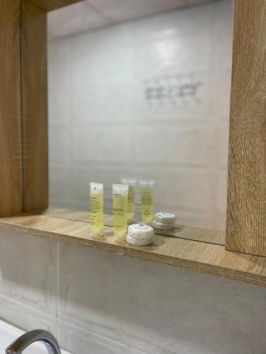 a shelf in a bathroom with three yellow candles at Wadi Rum Magic Camp in Wadi Rum
