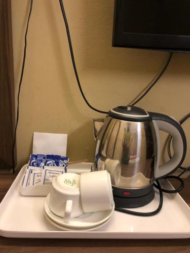 a tea kettle on top of a tray at HOTEL BREEZE NEW JALPAIGURI in Siliguri