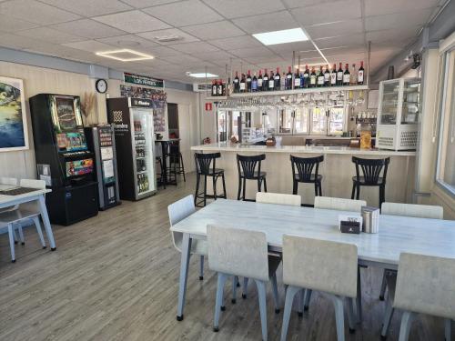 a restaurant with a table and chairs and a bar at Hotel La Duquesa in Pinos Genil