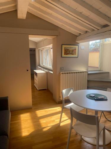 a living room with a table and chairs at Mansarda Salviatino in Florence