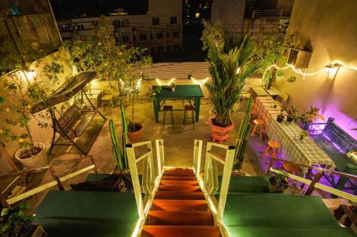 an overhead view of a patio with a table and plants at Happiness Community Wake & Bake Hostel - Rooftop Bar & Bistro in Pattaya