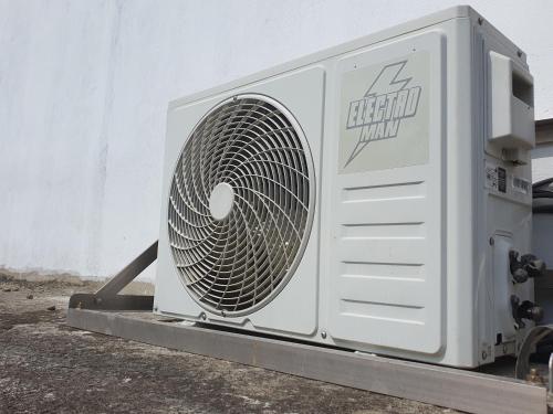 a white fan sitting on the side of a building at Sky homestay in Ampara